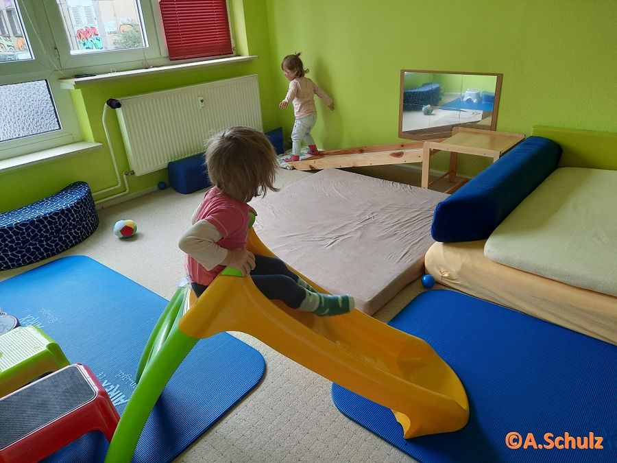 enlarge the image: In the extra room for gymnastics two children try out the slides.